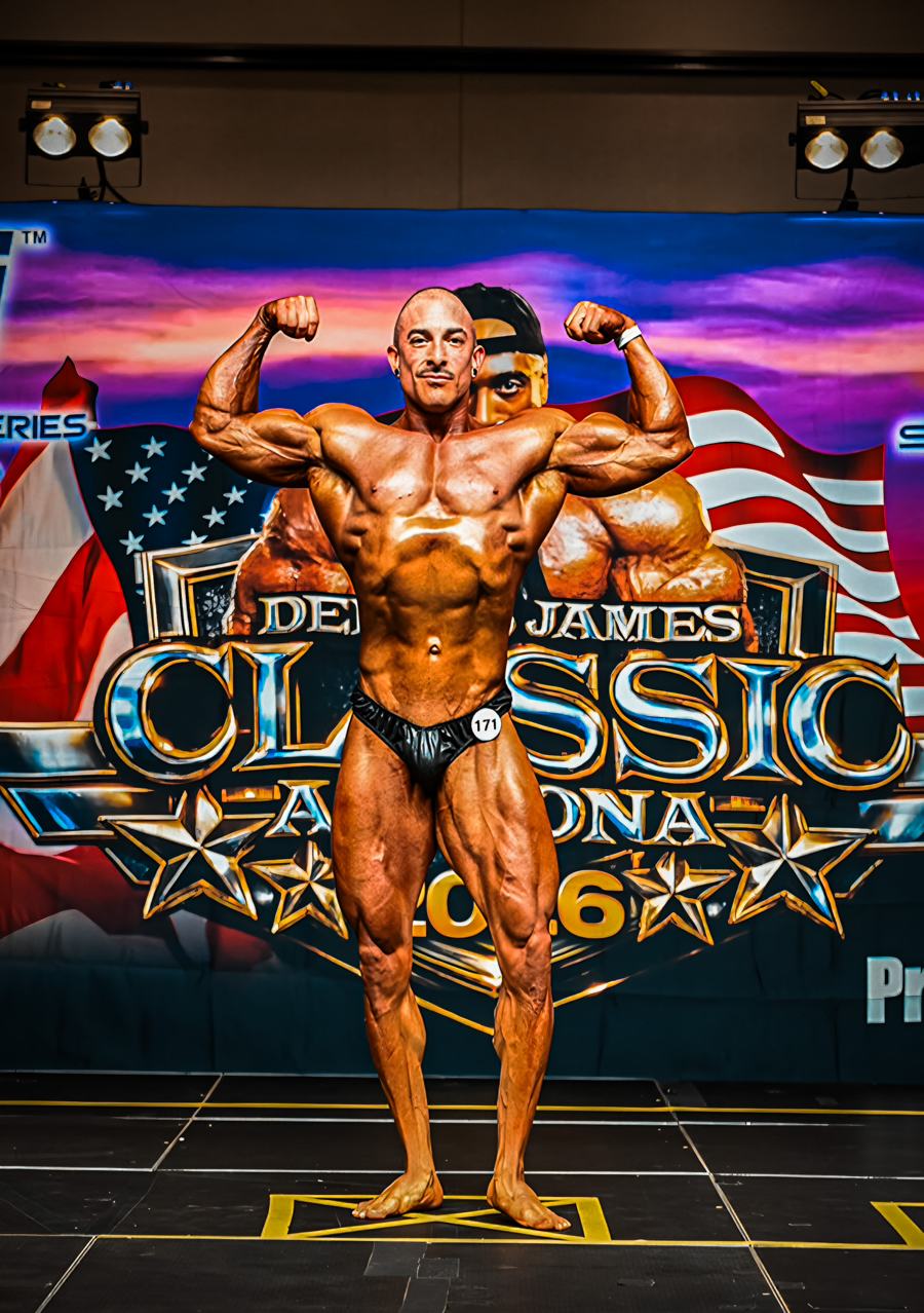 Adam Solis hitting a front double biceps on stage